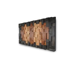 a wooden wall hanging on the side of a white wall with wood squares in it