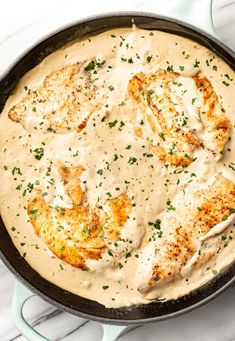 a skillet filled with chicken covered in gravy