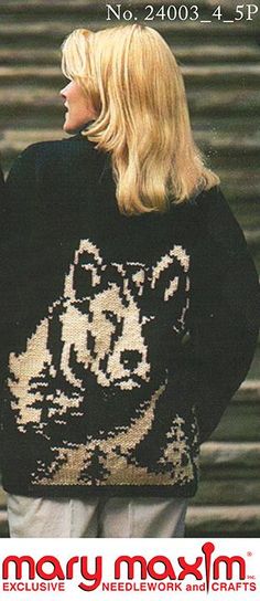 a woman with blonde hair wearing a black and white sweater that has an image of a cat on it