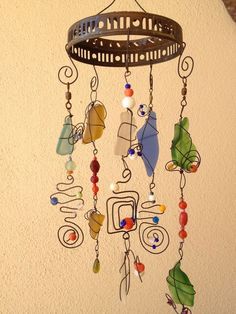 a wind chime hanging from the side of a wall