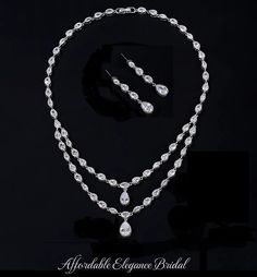 a necklace and earring set on display in a black background with the words available elegance bridal