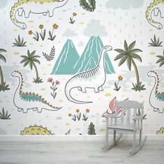 a child's rocking chair in front of a dinosaur wall mural