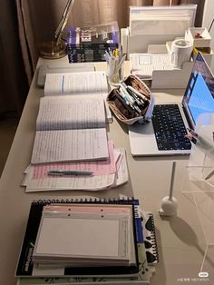 there are many papers and laptops on the desk with each one's own