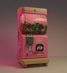 a pink gummy machine sitting on top of a table