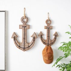 two wooden anchor hooks hang on the wall