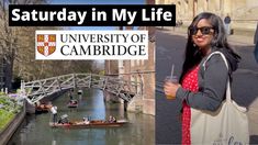 a woman holding a drink standing next to a river with boats in it and the words saturday in my life