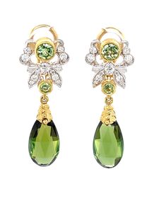 These pretty dangle earrings feature gem-quality green tourmalines that have been faceted as elegant pendeloques! Set in 18k yellow gold, these feminine drops are so elegant and sophisticated, set with bright, sparkling green tsavorite garnets and round brilliant cut diamonds. The gems are set in a striking combination of 18k yellow gold bezels and intricately detailed white gold designs. These earrings are an excellent example of fine craftsmanship, made in 18k gold by our Master Jewelers in Lo Luxury Elegant Earrings With Gemstone Accents, Luxury Green Teardrop Earrings, Luxury Green Dangle Earrings, Pretty Dangle Earrings, Pretty Earrings Dangle, Ear Drops, Tourmaline Earrings, Tsavorite Garnet, Gold Designs