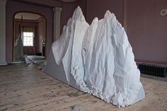 a large white piece of paper sitting on top of a wooden floor