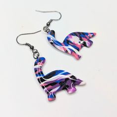 the earrings are made out of plastic and have colorful designs on them