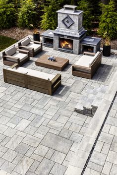 an outdoor fireplace and seating area is shown