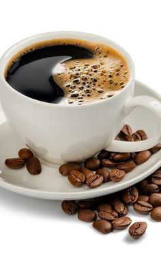 a cup of coffee and beans on a saucer