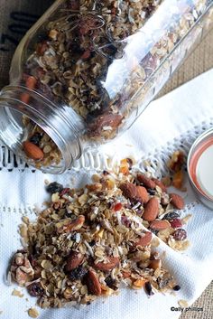 granola mix in a glass jar next to a cup of milk