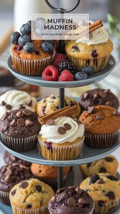 three tiered tray with cupcakes and muffins on it