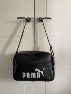 Thanks for visiting Beats and Treats. You are viewing a 1970's Puma Sports bag finished in Black vinyl with white Logo lettering. If you look at the "M" on the logo , the two indents on the top age this bag from the mid to late 70's. The later Logo from the 80's had a straight too to the M. In general terms the bag has aged really well, the zip and strap are fully working , it is very clean inside and out . The inner cardboard base is fully intact , the foor studs are all secure. There are no ri Puma Bag, Puma Sport, Sports Bags Gym, Sports Gym, Team Sports, Sport Gym, Black Vinyl, Sport Bag, Sports Team