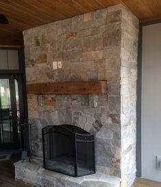 a stone fireplace is shown in this image