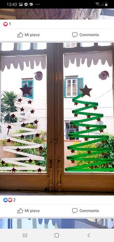 an image of a window decorated with christmas trees on the outside and stars on the inside