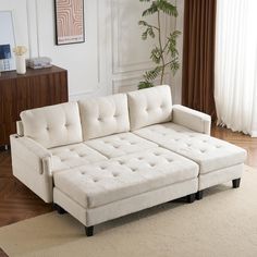 a white couch sitting on top of a wooden floor