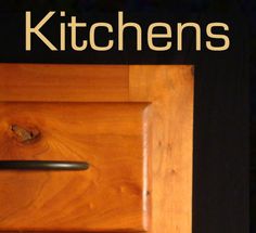 a wooden door with the words kitchen on it and an image of a knife sticking out of it