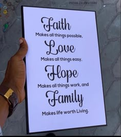 a person holding up a sign that says faith makes all things possible love makes all things easy hope makes all things work and family makes life worth living