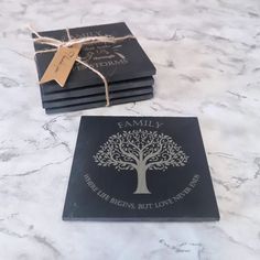 four personalized coasters with a tree on the front and back, tied in twine