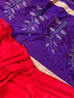 Red color with tiny Sequence Work all over the Saree. Purple/Blue Pallu with Thread and Sequence Work. Handloom Saree with Sequence Work. Item: Saree Color : Red Base Fabric: Silk Cotton Blouse piece : Yes Blouse material: Cotton Silk Work: Handloom Fall & Edging (Yes/No) : Yes Kindly note : Since this Saree is handmade hence little inconsistencies may be there however it is not considered as a defect. Every Saree is unique in its own way and weavers put in there heart and soul in weaving th Red Cotton Saree For Wedding, Red Cotton Dupatta With Zari Weaving, Red Cotton Saree With Dupatta, Red Bohemian Slub Silk Saree, Red Bohemian Slub Silk Dupatta, Saree Purple, Purple Blue Color, Sequence Saree, Floral Print Design