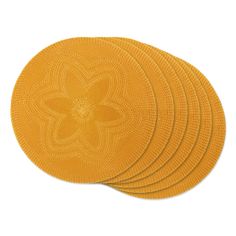 four yellow coasters with an intricate design on them