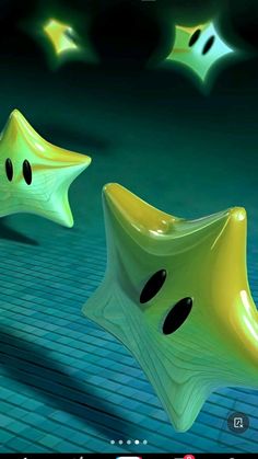 two yellow and black objects on a green surface with lights shining in the back ground