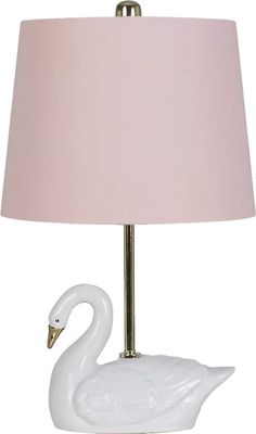 a white swan lamp with a pink shade on it's head and neck, sitting next to a light