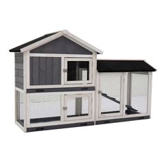 a large white chicken coop with black roof