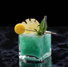 a green cocktail garnished with a pineapple