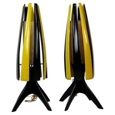 a pair of yellow and black clocks sitting on top of each other