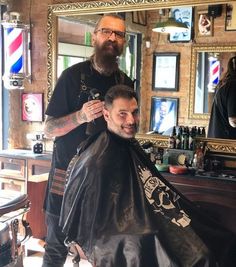 a man getting his hair cut at a barber shop