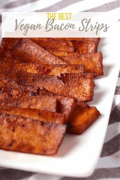 the best vegan bacon strips on a white plate with black and white checkered table cloth