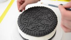 someone is decorating an oreo cookie cake