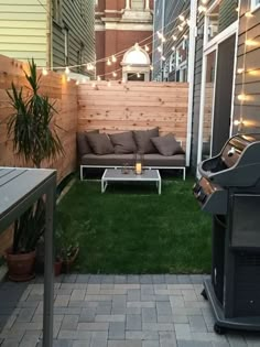 an outdoor living area with patio furniture and string lights