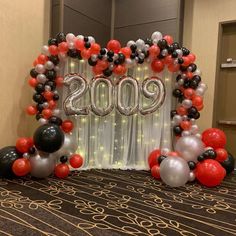 balloons and streamers in the shape of numbers are on display at an entrance to a banquet hall