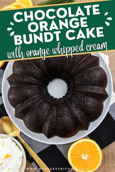 chocolate bundt cake with orange whipped cream on a white plate next to an orange slice