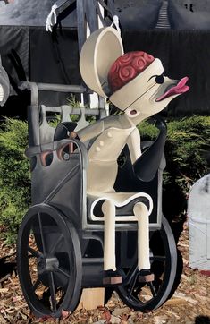 a statue of a mouse in a carriage