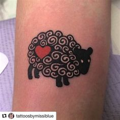 a tattoo with a black sheep and a heart on it