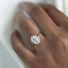 a woman's hand with a diamond ring on it