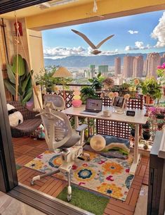 an office area with a desk, chair and bird statue on the window sill