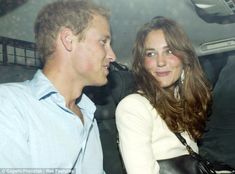 a man and woman sitting in the back seat of a car looking into each other's eyes