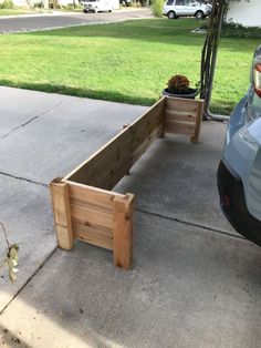 a car parked next to a wooden planter box