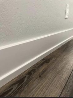 a white wall and wood floor in an empty room with the words, how to install lam