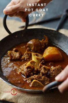 a person holding a pan filled with stew