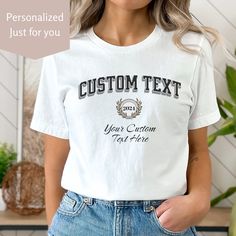 Celebrate school pride with this custom college t-shirt. An Ivy League aesthetic features personalized college font and script font along with a customizable date. Perfect college apparel for matching team shirts, graduation gifts, college admissions and in support of your favorite college or student.  MATCHING Custom Sweatshirt: https://deesinspire.etsy.com/listing/1644438694 Send a message to Denise with any questions. ~T-Shirt~ ✦ 100% Airlume combed and ring-spun cotton, (4.2 oz/yd² (142 g/m making it lightweight and soft (see below for color variation fabric blends) ✦ Bella+Canvas manufactures all its products in the US and internationally in humane, no-sweat-shop, sustainable way and is part of the Fair Labor Association as well as Platinum WRAP certified. ✦ Tear away product tag for Collegiate Letter Print T-shirt For School, College Style Crew Neck T-shirt For College Events, Varsity Tops With Team Name For College Events, Customizable Crew Neck School T-shirt, School Spirit T-shirt With Letter Print For College Events, Collegiate Tops For College Events, Customizable Cotton T-shirt For School Spirit, Varsity Style Letter Print T-shirt For School, White Varsity T-shirt For School