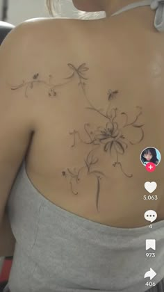 the back of a woman's shoulder with flowers on it