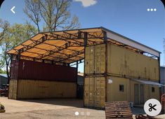 an image of a building made out of shipping containers that is being used as a shelter