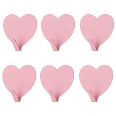 pink heart shaped paper clips are arranged in rows on a white background with clippings