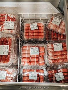 packaged meats are displayed in plastic containers